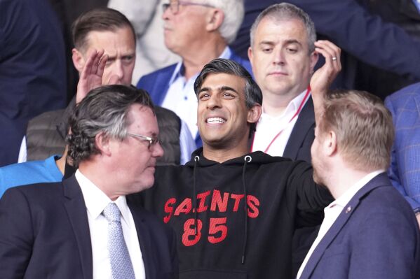 Britain's Prime Minister Rishi Sunak gestures in the stands during the Sky Bet Championship play-off, semi-final, second leg match between West Bromwich Albion and Southampton at St Mary's Stadium in Southampton, Friday May 17, 2024. (Adam Davy/PA via AP)
