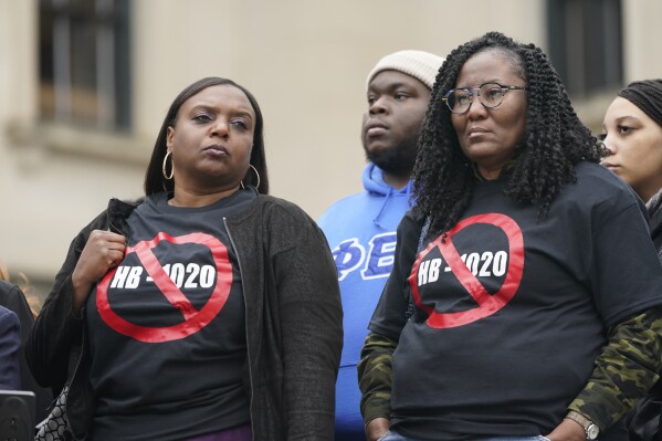 FILE - People voicing their opposition to Mississippi House Bill 1020 wear protest t-shirts as they gathered on the steps of the Mississippi Capitol in Jackson, Jan. 31, 2023. A federal judge will consider arguments over racial discrimination, public safety and local democracy as he decides whether to block appointments to a new state-run court in part of Mississippi's majority-Black capital city set to be created on Monday, Jan. 1, 2024. (AP Photo/Rogelio V. Solis, File)
