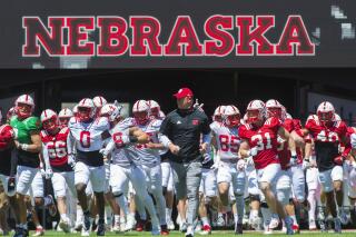 Nebraska head coach Scott Frost and the Huskers run on to the field to a sea of fans for the first time since the pandemic started before the Red-White Spring game at Memorial Stadium in Lincoln, Neb. on Saturday, May 1, 2021. (Kenneth Ferriera/Lincoln Journal Star via AP)
