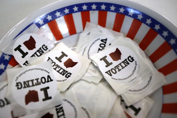 FILE - This is a bowl of stickers for those taking advantage of early voting, Sunday, March 15, 2020, in Steubenville, Ohio. Small business owners are more undecided about the election than the general public. That's according to a new survey by Goldman Sachs 10,000 Small Businesses Voices. (AP Photo/Gene J. Puskar, File)