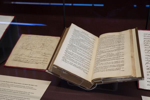 A "slave bible" published in 1808, right, with all references to freedom from slavery removed, is displayed at the exhibition in the Lambeth Palace Library, in London, Tuesday, Jan. 31, 2023. A letter written by an enslaved person in Virginia 300 years ago seeking freedom is part of a new exhibition exploring the Church of England's historic links to slavery. It's part of efforts by the Anglican church to reckon with its historic complicity in slavery. (AP Photo/Kin Cheung)