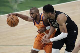 Phoenix Suns guard Chris Paul (3) drives to the basket against Milwaukee Bucks forward Giannis Antetokounmpo (34) during the first half of Game 6 of basketball's NBA Finals Tuesday, July 20, 2021, in Milwaukee. (AP Photo/Aaron Gash)