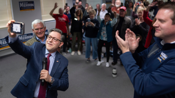 Speaker of the House Mike Johnson, R-La., second from left, joined by Rep. Bob Latta, R-Ohio, left, and Ohio state Rep. Derek Merrin, right, takes a selfie to send to Republican presidential nominee former President Donald Trump as he speaks during a campaign event at the Lucas County Republican Party headquarters in Holland, Ohio, Saturday, Oct. 26, 2024. (AP Photo/Carolyn Kaster)