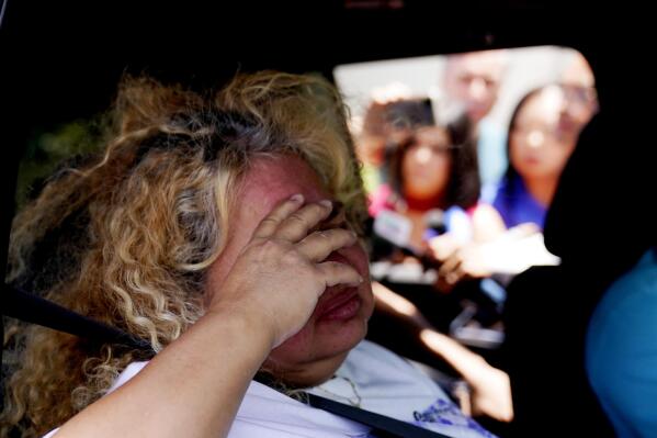 Grace Valencia, great aunt of shooting victim Uziyah Garcia, talks to the media from a vehicle after picking up a copy of the Texas House investigative committee report on the shootings at Robb Elementary School, Sunday, July 17, 2022, in Uvalde, Texas. (AP Photo/Eric Gay)