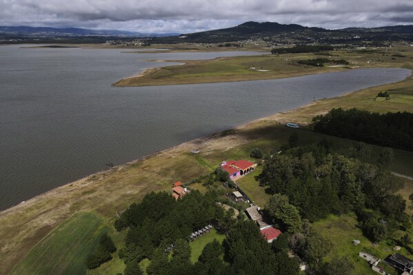 The banks of the Villa Victoria reservoir are exposed due to low water levels in the state of Mexico, Tuesday, Oct. 10, 2023. The capital’s reservoirs like Villa Victoria are running historically low following a “too dry” summer, according to official data, and as the rainy season draws to a close, water restrictions have already begun. (AP Photo/Marco Ugarte)