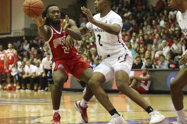 Ohio State guard Bruce Thornton (2) makes a pass away from Cincinnati guard Landers Nolley II during the first half of an NCAA college basketball game, Tuesday, Nov. 22, 2022, in Lahaina, Hawaii. (AP Photo/Marco Garcia)