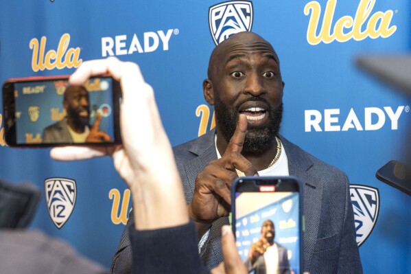 New UCLA college football head coach DeShaun Foster takes questions from reporters during an introductory press conference at Pauley Pavilion on the UCLA campus in Los Angeles on Tuesday, Feb. 13, 2024. (AP Photo/Damian Dovarganes)