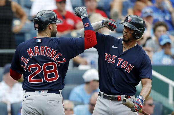 Boston Red Sox's J.D. Martinez (28) is congratulated by Xander Bogaerts (2) after hitting a two-run home run in the fifth inning of a baseball game against the Kansas City Royals at Kauffman Stadium in Kansas City, Mo., Saturday, June 19, 2021. (AP Photo/Colin E. Braley)