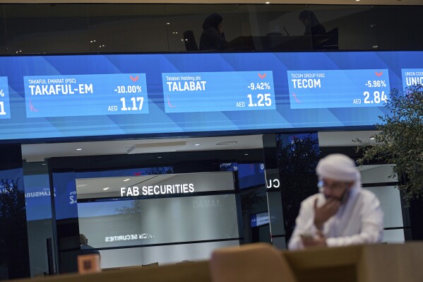 An Emirati man is seen in the Dubai Financial Market in Dubai, United Arab Emirates, Monday, April 7, 2025. (AP Photos/Fatima Shbair, File)