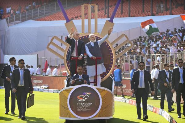 Indian Prime Minister Narendra Modi with his Australian counterpart Anthony Albanese wave as they arrive in the stadium to watch fourth cricket test match between India and Australia in Ahmedabad, India, Thursday, March 9, 2023. (AP Photo/Ajit Solanki)