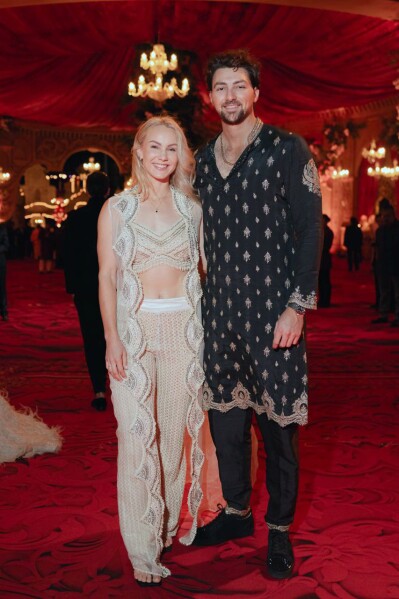 This photograph released by the Reliance group shows Australian cricketer Tim David and his wife Stephanie Kershaw posing for a photograph at a pre-wedding bash of Mukesh Ambani's son Anant Ambani in Jamnagar, India, Saturday, Mar. 02, 2024. (Reliance group via AP)