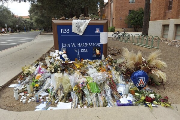 FILE - A memorial for University of Arizona professor Thomas Meixner is seen outside the school's Department of Hydrology and Atmospheric Sciences building in Tucson, Ariz., Oct. 14, 2022. A jury was seated Tuesday, May 7, 2024, for the trial of a former University of Arizona graduate student accused of fatally shooting Meixner in 2022 after he was banned from campus because of harassment complaints. (AP Photo/Terry Tang, File)