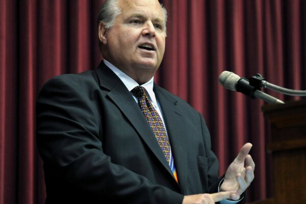 FILE - In this May 14, 2012 file photo, Rush Limbaugh speaks during a ceremony inducting him into the Hall of Famous Missourians in the state Capitol in Jefferson City, Mo. Florida Gov. Ron DeSantis is moving ahead with plans to honor the recently deceased conservative radio broadcaster by lowering flags to half-staff despite protests from some public officials who don’t see Limbaugh as worthy of the honor. (AP Photo/Julie Smith, File)