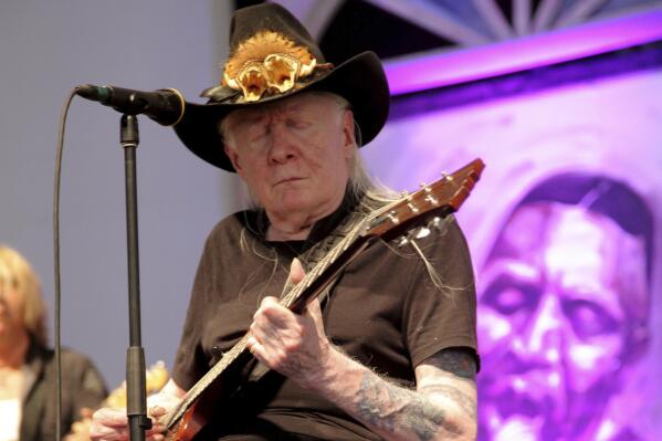 FILE - Johnny Winter performs at the New Orleans Jazz & Heritage Festival at Fair Grounds Race Course in New Orleans, May 3, 2014. Nearly nine years after Johnny Winter's death, a battle for control of the legendary blues guitarist's music is being fought in a Connecticut court with nasty allegations of theft and greed flying. (Photo by John Davisson/Invision/AP, File)