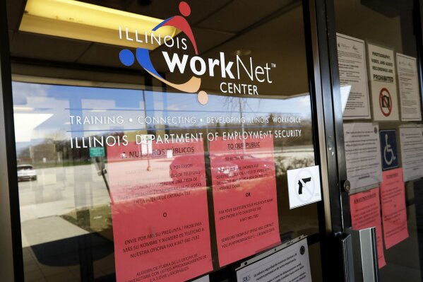 Information papers display at IDES (Illinois Department of Employment Security) WorkNet center in Arlington Heights, Ill., Thursday, April 9, 2020. Another 6.6 million people filed for unemployment benefits last week, according to the US Department of Labor, as American workers continue to suffer from devastating job losses, furloughs and reduced hours during the coronavirus pandemic. (AP Photo/Nam Y. Huh)