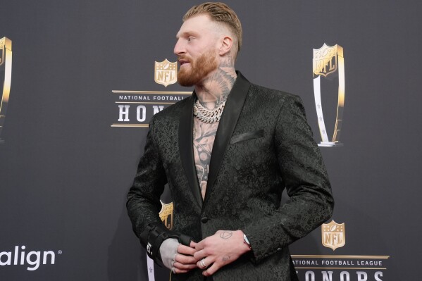 Maxx Crosby of the Las Vegas Raiders stands on the red carpet at the NFL Honors award show ahead of the Super Bowl 58 football game Thursday, Feb. 8, 2024, in Las Vegas. (AP Photo/Charlie Riedel)