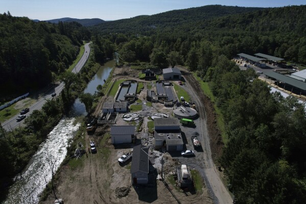 This photo shows a damaged wastewater treatment plant on Aug. 2, 2023, in Ludlow, Vt. Across the U.S., municipal water systems and sewage treatment plants are at increasing risk of damage from floods and sea-level rise brought on in part or even wholly by climate change. The storm that walloped Ludlow especially hard, damaging the picturesque ski town’s system for cleaning up sewage before it’s discharged into the Williams River. (AP Photo/Charles Krupa)