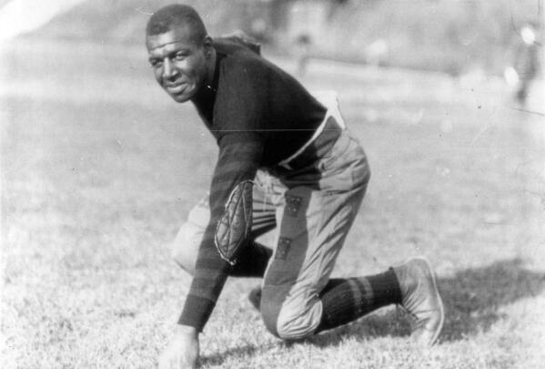 Iowa football player Frederick "Duke" Slater poses for a photo in 1921  Slater was the NFL’s first African-American lineman, and often the only Black player on the field. After retiring, he broke down more racial barriers to become a judge in Chicago. (Chicago Sun-Times via AP)