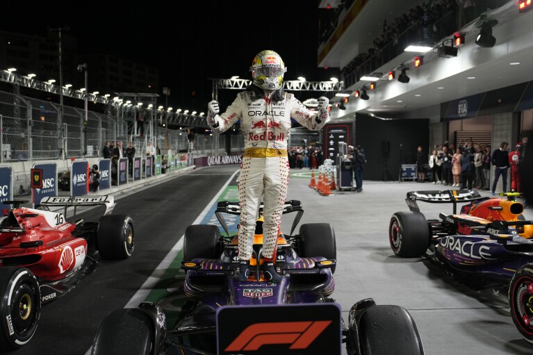 Red Bull driver Max Verstappen, the Dutchman, stands on top of his car after winning the Formula 1 Las Vegas auto race, Saturday, November 18, 2023, in Las Vegas. (AP Photo/John Lusher)