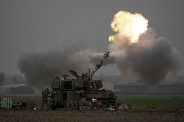 An Israeli mobile artillery unit fires a shell from southern Israel towards the Gaza Strip, in a position near the Israel-Gaza border on Thursday, Dec. 14, 2023. (AP Photo/Leo Correa, File)
