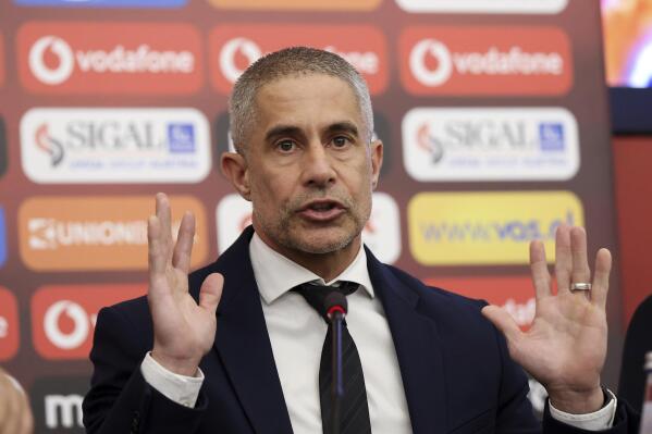 The new coach of Albania national soccer team Brazilian Sylvio Mendes Campos gestures during a press conference in Tirana, Albania, Monday, Jan. 9, 2023. The Albanian soccer federation has signed an 18-month contract with Sylvio Mendes Campos Junior to coach the country’s national team aiming at reaching the 2024 Euro finals. The Brazilian, 48, known as Sylvinho, signed a contract on Monday to lead the Albanian national team until the end of European Championship. No financial details were made available. (AP Photo/Franc Zhurda)