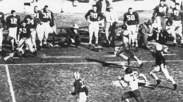 File-This Jan. 1, 1954, file photo shows Alabama fullback Tommy Lewis (42) (arrow) coming off the bench getting ready to tackle Rice halfback Dicky Moegle (47), as he crosses the 50 yard line during the Cotton Bowl at Arlington, Tex., Jan. 1, 1954.  Maegle, the Rice running back tackled in the 1954 Cotton Bowl by an Alabama player who came off the bench in one of the most legendary plays in college football history, has died.  Rice and the National Football Foundation both said Tuesday, July 6, 2021, that Maegle passed away Sunday. He was 86. (Tom Dillard/The Dallas Morning News via AP)