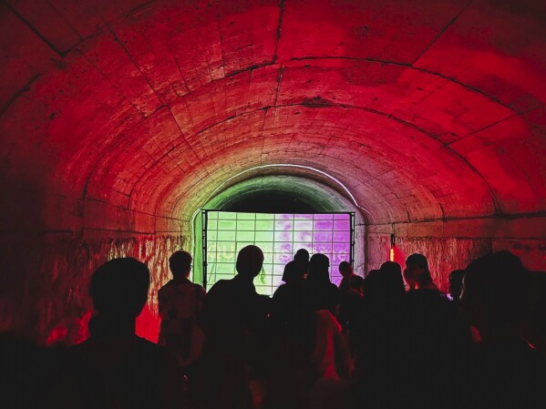 Rave attendees dance in an abandoned air raid shelter in Guangzhou, China on Aug. 20, 2023. (Fang Qi via AP)