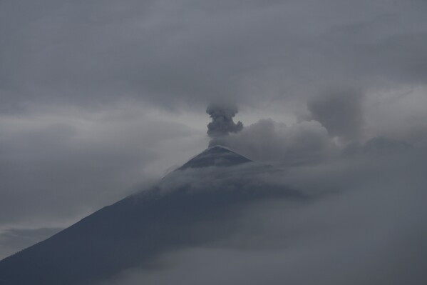 The Fuego Volcano blows out a cloud of ash, as seen from San Juan Alotenango, Guatemala, Thursday, June 5, 2025. (AP Photo/Moises Castillo)
