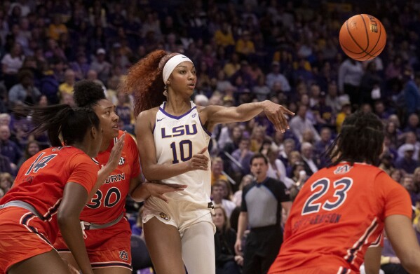 LSU forward Angel Reese (10) passes the ball away from Auburn forward Taylen Collins (14), center Savannah Scott (30) and guard Honesty Scott-Grayson (23) during an NCAA college basketball game Thursday, Feb. 22, 2024, in Baton Rouge, La. (Hilary Scheinuk/The Advocate via AP)