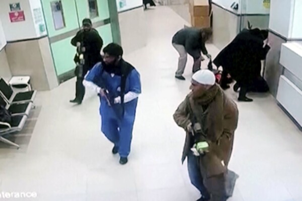 In this image taken from surveillance video provided by the Palestinian Health Ministry, Israeli forces disguised as civilians and medical workers hold weapons in a hallway at the Ibn Sina Hospital in the West Bank town of Jenin, Tuesday, jan 30, 2024, in the occupied West Bank, killing three Palestinian militants in a dramatic raid that underscored how deadly violence has spilled into the territory from the war in Gaza. (Palestinian Health Ministry via AP)