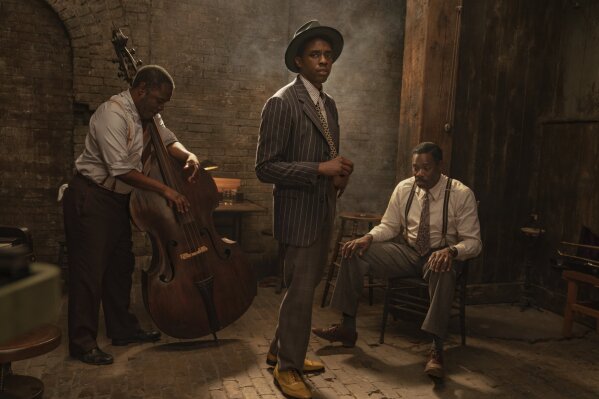 This image released by Netflix shows Michael Potts, from left, Chadwick Boseman and Colman Domingo in "Ma Rainey's Black Bottom." Boseman was nominated for a Golden Globe for best actor in a motion picture drama on Wednesday, Feb. 3, 2021 for his role in the film. (David Lee/Netflix via AP)