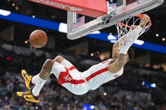 Houston Rockets' K.J. Martin dunks during the first half of an NBA basketball game against the San Antonio Spurs, Saturday, March 4, 2023, in San Antonio. (AP Photo/Darren Abate)