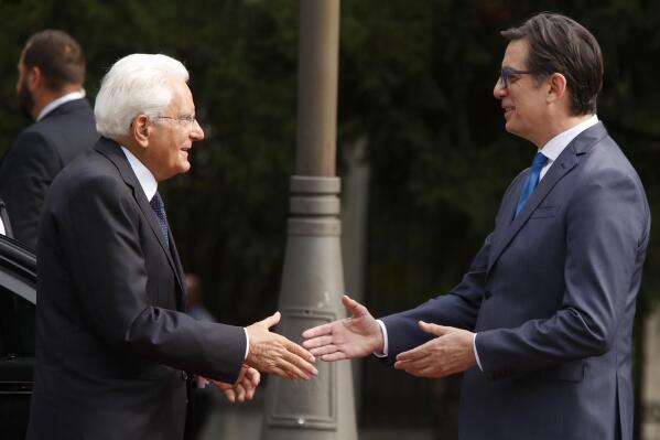 Italian President Sergio Mattarella, left, is welcomed by North Macedonia's President Stevo Pendarovski, at the presidential palace in Skopje, North Macedonia, on Friday, Sept. 9, 2022. Italian President Mattarella is on a two-day official visit to North Macedonia. (AP Photo/Boris Grdanoski)