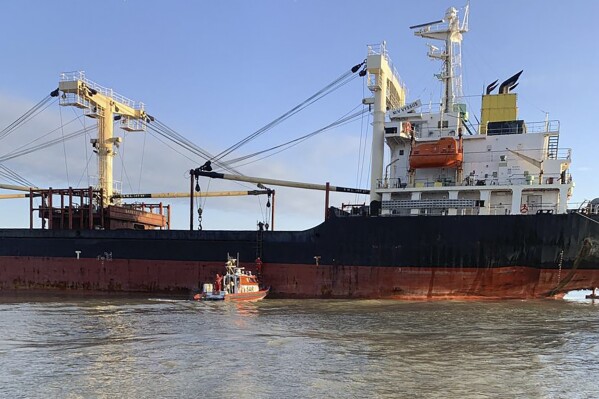 In this photo provided by Ukraine's Border Guard Service, a Panama-flagged civilian cargo vessel is seen in Odesa region Thursday, Dec. 28, 2023. The vessel hit a Russian mine resulting in two injured sailors, said Ukraine's Southern Defense Forces on Thursday. The vessel was supposed to arrive to one of Danube ports to load the grain. (Ukraine's Border Guard Service via AP Photo)