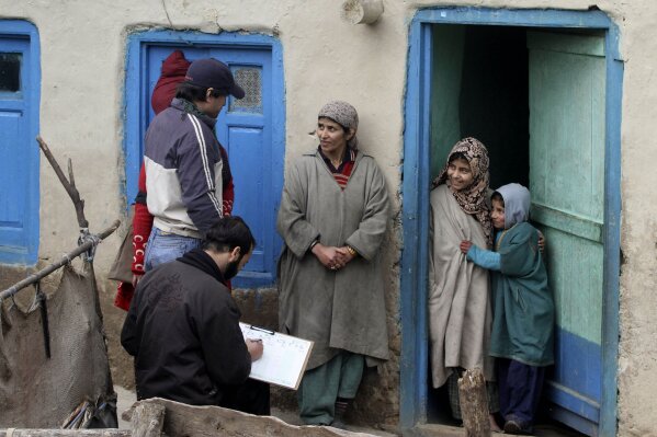 In this Wednesday, Feb. 9, 2011, file photo, census workers take details of a Kashmiri family on the outskirts of Srinagar, India. India has been embroiled in protests since December, when Parliament passed a bill amending the country's citizenship law. (AP Photo/Mukhtar Khan, File)