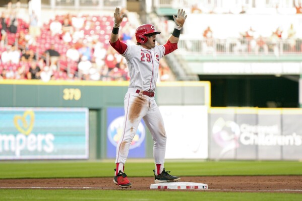 Cincinnati Reds' TJ Friedl (29) reacts after hitting a two-run triple against the Miami Marlins during the third inning of a baseball game Monday, Aug. 7, 2023, in Cincinnati. (AP Photo/Jeff Dean)