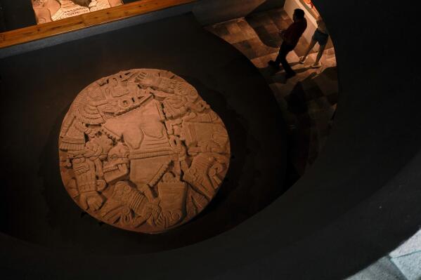 A monolith depicting Coyolxauhqui is exhibited at the Museum of Templo Mayor, marking the 45th anniversary of the circular stone’s discovery, in Mexico City, Wednesday, March 29, 2023. “Coyolxauhqui: The star, the goddess, the discovery” exhibition displays more than 150 archaeological objects focused on the mythology, symbolism and scientific research around the Mexica lunar goddess. (AP Photo/Eduardo Verdugo)