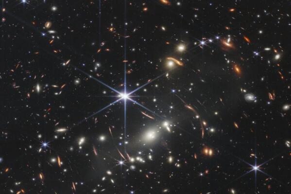 This image provided by NASA on Monday, July 11, 2022, shows galaxy cluster SMACS 0723, captured by the James Webb Space Telescope. The telescope is designed to peer back so far that scientists can get a glimpse of the dawn of the universe about 13.7 billion years ago and zoom in on closer cosmic objects, even our own solar system, with sharper focus. (NASA/ESA/CSA/STScI via AP)