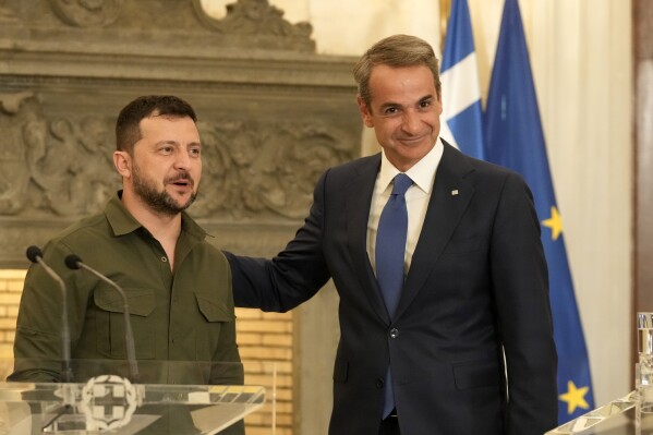 Ukraine's President Volodymyr Zelenskyy, left, and Greece's Prime Minister Kyriakos Mitsotakis pose after their statements at Maximos Mansion in Athens, Greece, Monday, Aug. 21, 2023. Zelenskyy flew to Greece Monday for talks with the country's leadership and to attend an informal meeting of Balkan leaders with top European Union officials. (AP Photo/Thanassis Stavrakis)