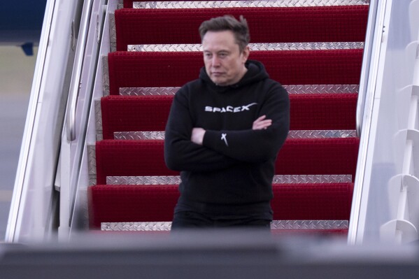Elon Musk arrives on Air Force One at Philadelphia International Airport, March 22, 2025, in Philadelphia. (AP Photo/Chris Szagola, File)