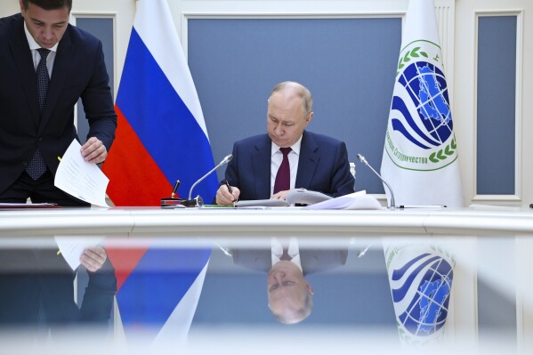 Russian President Vladimir Putin attends a signing ceremony during a meeting of the Shanghai Cooperation Organisation (SCO) Heads of State Council via videoconference at the Kremlin, in Moscow, Russia, Tuesday, July 4, 2023. (Alexander Kazakov, Sputnik, Kremlin Pool Photo via AP)
