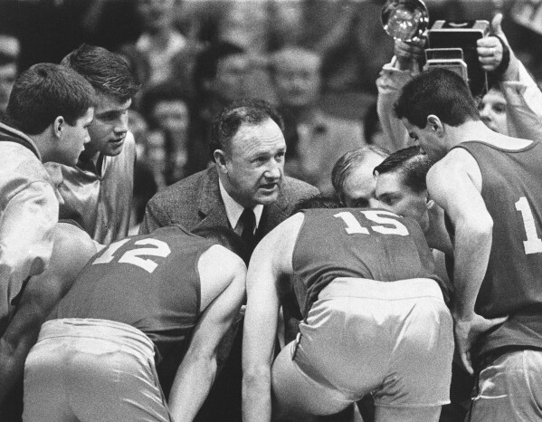 Actor Gene Hackman gives fictional Hickory High basketball players instructions during filming of the final game of the movie "Hoosiers" at Hinkle Fieldhouse on the Butler University campus, Friday, Dec. 6, 1985 in Indianapolis. (AP Photo/Tom Strickland, File)