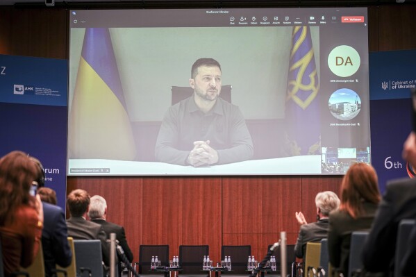 Ukrainian President Volodymyr Zelenskyy speaks during a live broadcast at the 6th German-Ukrainian Business Forum of the DIHK, the Committee on Eastern European Economic Relations and the German-Ukrainian Chamber of Industry and Commerce (AHK Ukraine), in Berlin, Tuesday, Oct. 24, 2023. Topics include infrastructure, energy and defense as well as investment conditions for German companies in Ukraine. (Kay Nietfeld/dpa via AP)