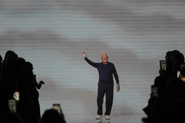 Designer Giorgio Armani accepts applause after the conclusion of his women's Spring Summer 2024 collection presented in Milan, Italy, Sunday, Sept. 24, 2023. (AP Photo/Luca Bruno)