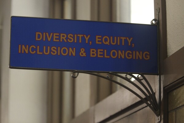 FILE - The sign above the door to the Office of Diversity, Equity, Inclusion and Belonging inside the main administration building on the main University of Kansas campus is seen on Friday, April 12, 2024, in Lawrence, Kan. A conservative quest to limit diversity, equity and inclusion initiatives is gaining momentum in state capitals and college governing boards, with officials in about one-third of the states now taking some sort of action against it. (AP Photo/John Hanna, File)