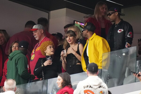 Taylor Swift and Ice Spice, left, talk before the NFL Super Bowl 58 football game between the San Francisco 49ers and the Kansas City Chiefs, Sunday, Feb. 11, 2024, in Las Vegas. (AP Photo/Frank Franklin II)