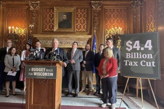 Wisconsin state Sen. Howard Marklein, surrounded by Republican lawmakers, discusses $4.4 billion in GOP tax cuts, including a $3.5 billion income tax cut, that are part of the state budget unveiled on Thursday, June 22, 2023, at a news conference in the state Capitol in Madison, Wis. (AP Photo/Scott Bauer)