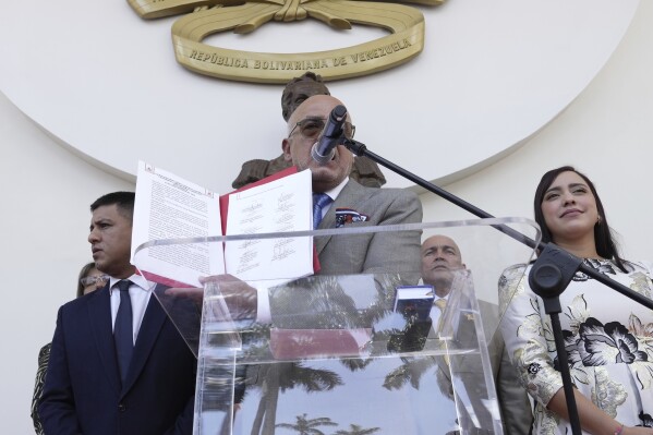 National Assembly President Jorge Rodriguez shows the signed document that agrees on varios presidential election dates to propose to the National Elections Council (CNE), at the end of the signing ceremony at the National Assembly, in Caracas, Venezuela, Wednesday, Feb. 28, 2024. (AP Photo/Matias Delacroix)