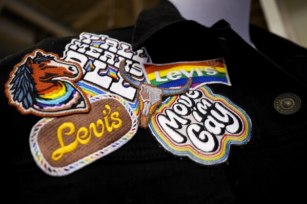 A jacket with patches from Levi's Pride collection is displayed at a Levi's Store in downtown Chicago, Monday, June 10, 2024. Many big retailers, including Levi's, Target, Old Navy and Urban Outfitters, have put out Pride collections for years. (AP Photo/Nam Y. Huh)