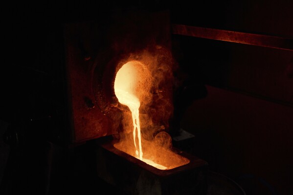 Molten gold is poured into a mold at A&M Precious Metals in the St. Vincent Jewelry Center in the Jewelry District of Los Angeles, Friday, May 2, 2025. (AP Photo/Jae C. Hong)
